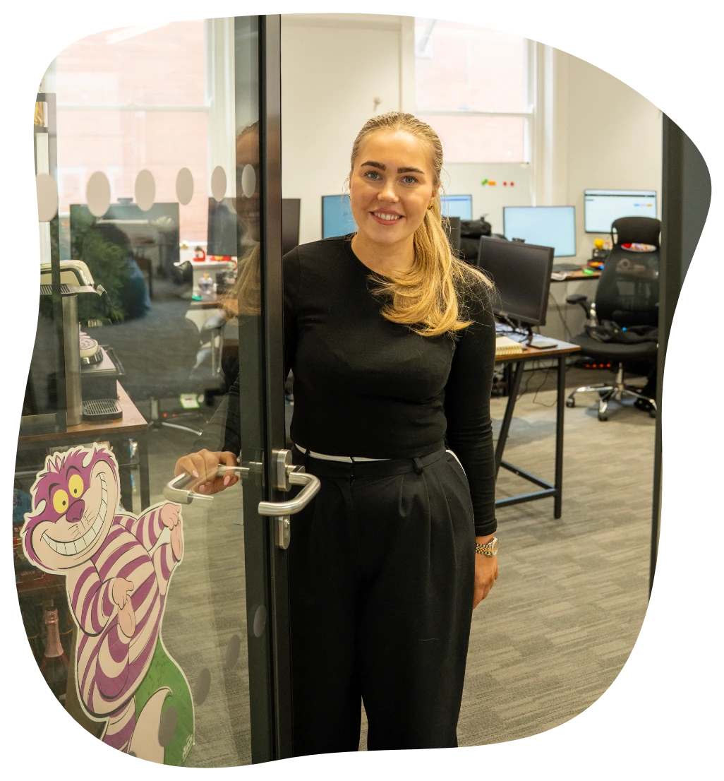 We hate marketing Kathleen holding open the office door